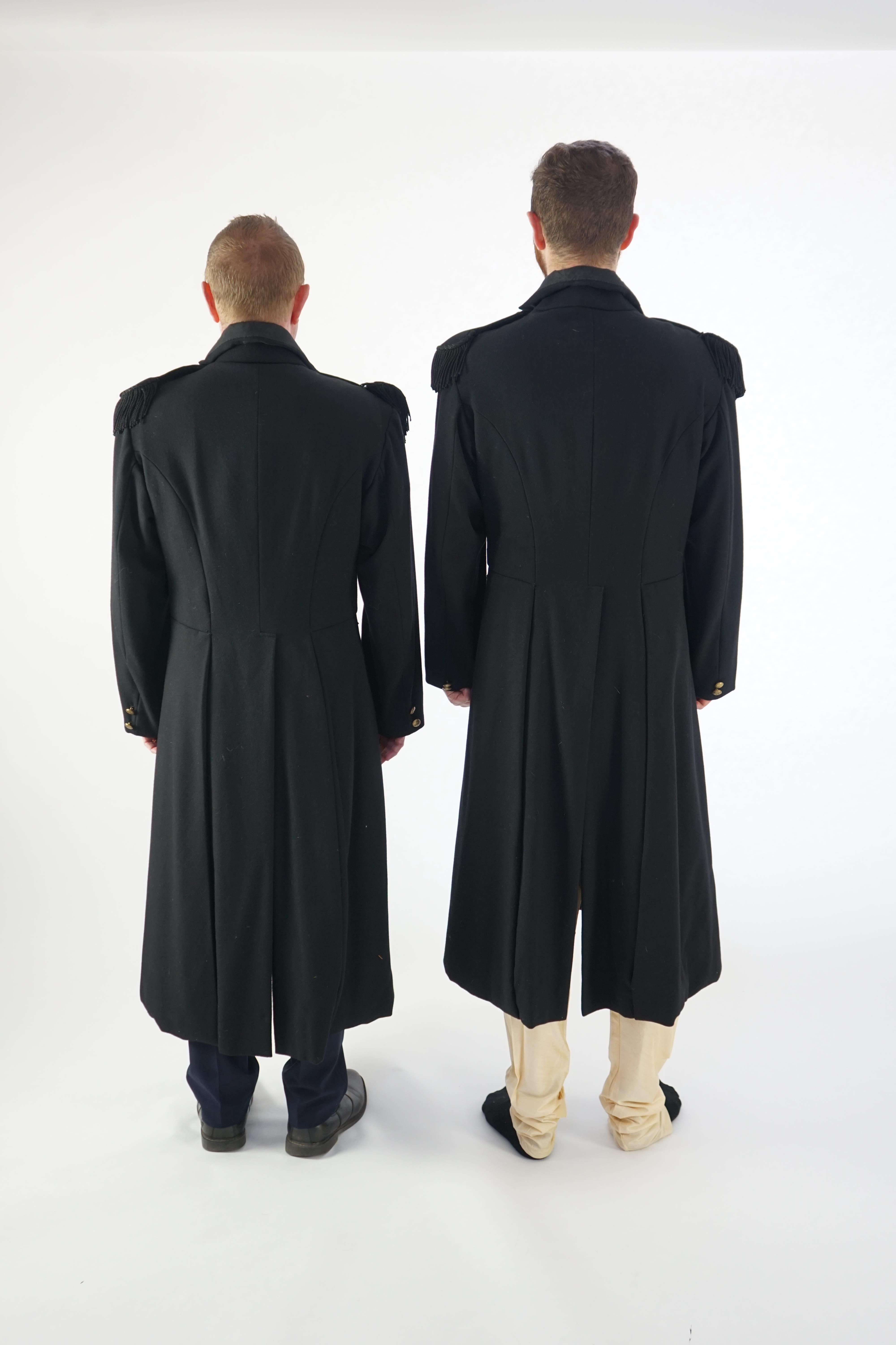 Two black military great coats with epaulettes and buttons. Ex Royal Opera House 'Tosca'